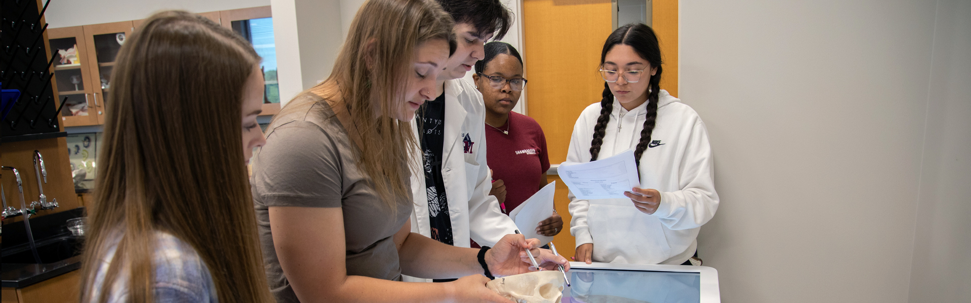 Students around a biology table.