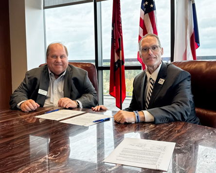 Cadence Bank Texarkana Market President George Merrill (left) and A&M-Texarkana President Dr. Ross Alexander sign a memorandum of understanding forming a partnership between the bank and the university.