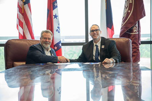 Photo: Nash, Texas City Administrator Doug Bowers (left) and A&M-Texarkana President Dr. Ross Alexander (right) shake hands at the signing of a new partnership agreement between the City of Nash and the university. The new partnership allows full-time city employees to receive significant  discounts on tuition at A&M-Texarkana.