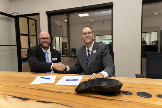 Frank Halter (left), Diamond Bank Market President and Dr. Ross Alexander, President of Texas A&M University-Texarkana shake hands after signing a partnership between the financial institution and the university.