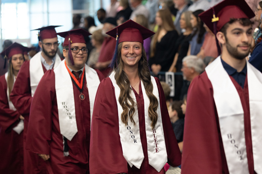 “Honor Graduate and Eagles softball player Sadie Parker, from Brandon, MS, walks into her commencement ceremony on May 11, 2024. Sadie graduated Summa Cum Laude with a biology degree and will be attending physical therapy school in her home state of Mississippi.”