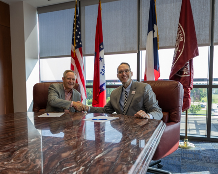 Marc Buxton (left), President and General Manager of Smith-Blair, a Xylem brand, shakes hands with A&M-Texarkana President Dr. Ross Alexander after signing a memorandum of understanding forming a partnership between the company and A&M-Texarkana.