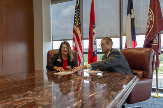 Dorie Pearson, Owner of Texarkana Therapy Center and Dr. Ross Alexander, President of A&M-Texarkana sign a partnership agreement between the university and the health care provider.